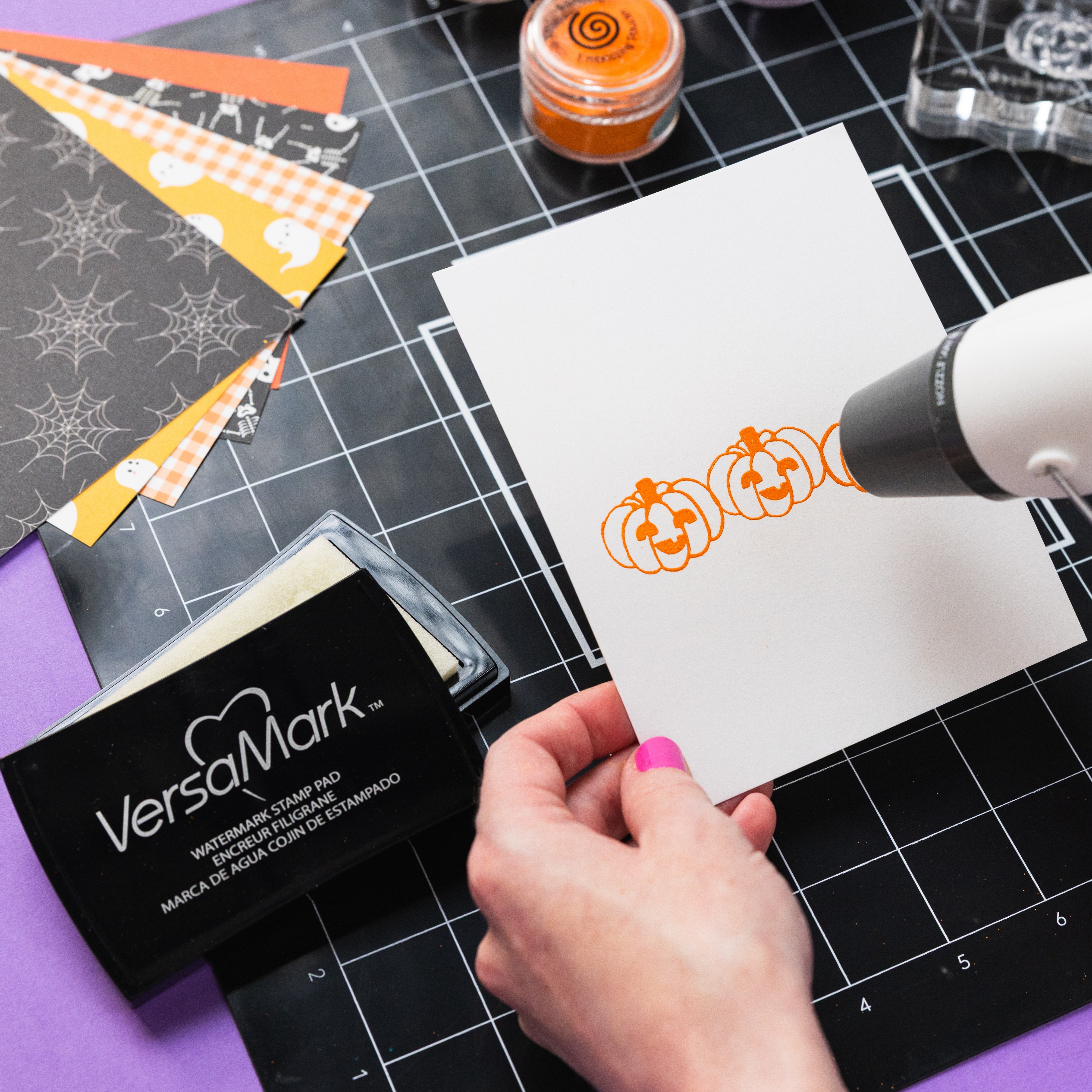 versamark embossing powder in use creating halloween card with orange embossing powder