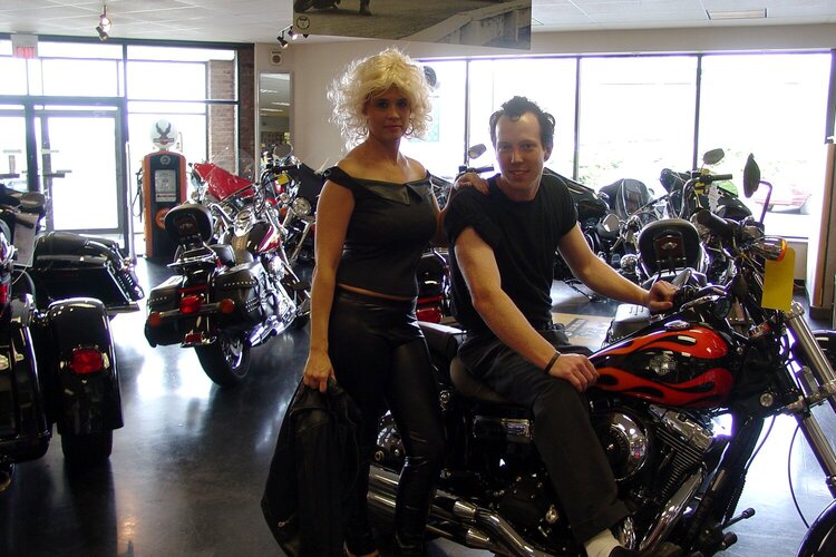 Sandy and Danny riding a harley
