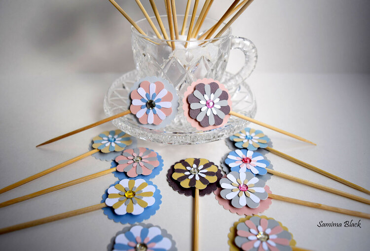 Flower shaped cupcake toppers in soft pastel colors
