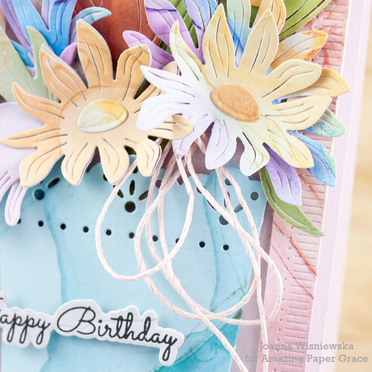 A birthday card with a bouquet in a vase