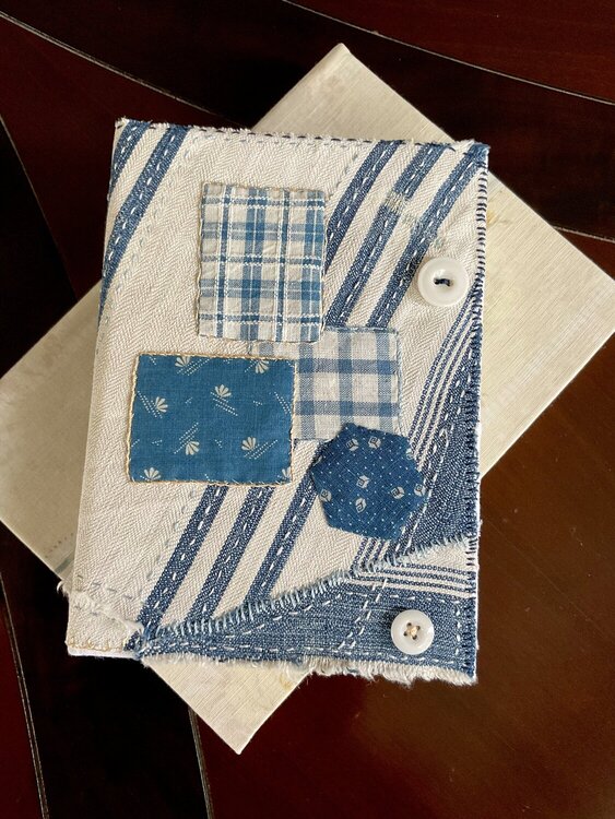 Journal made with a stitched cover of antique fabrics.  