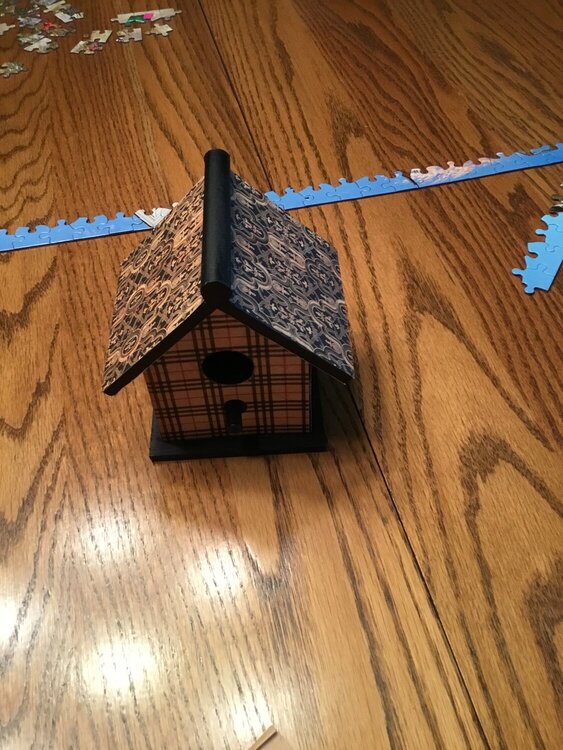 Decorated birdhouse with scrap papers