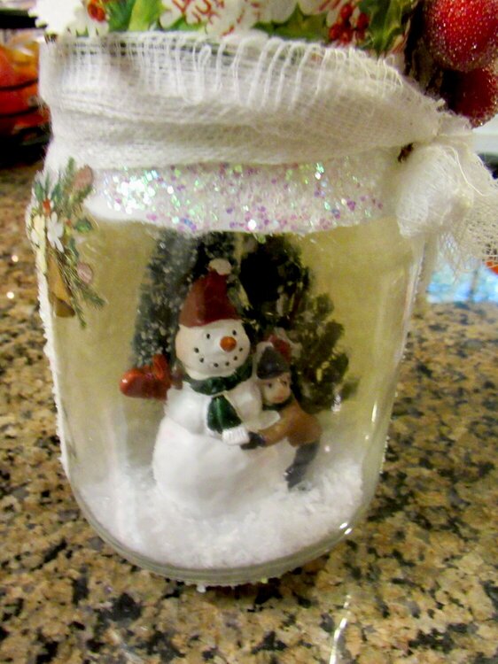 Mason jar with a Christmas scene