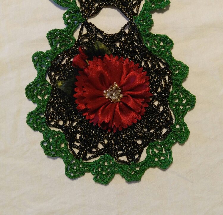 Closeup of Crochet Poinsettia Scarf with Prima Flower