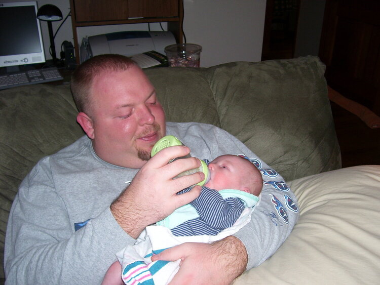 Uncle John feeds his first baby