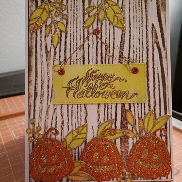 Tim holtz, glitter paper and a wood fence embossing folder. Also used fall leaf die cuts