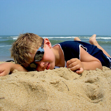 Laying in the sand.