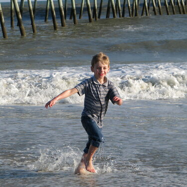 Zach runnning in the waves