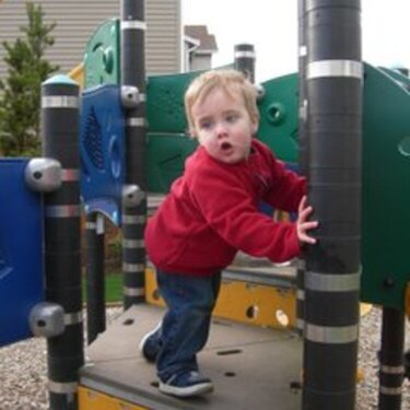 Bryce climbing up the playground equipment