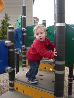 Bryce climbing up the playground equipment