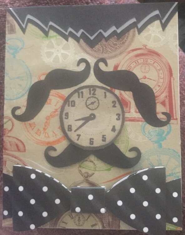 Do you see a clock or a man with a bow tie?