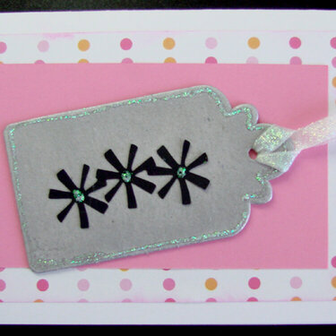 Birthday card in pink, orange and black with a tag