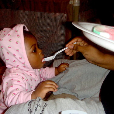 Leah eating the watermelon sorbet with her daddy