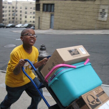 PRICELESS NAJEE HELPING WITH THE HAND TRUCK...