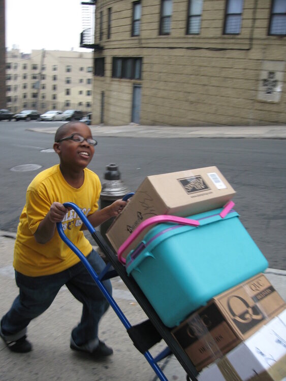 PRICELESS NAJEE HELPING WITH THE HAND TRUCK...