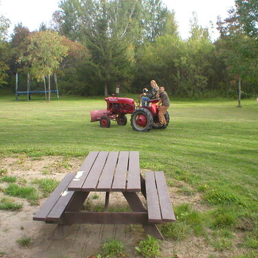 cathy and James on tractor. thomas taking the pic