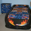 The finished quilt on his new bed! Hot Rod!