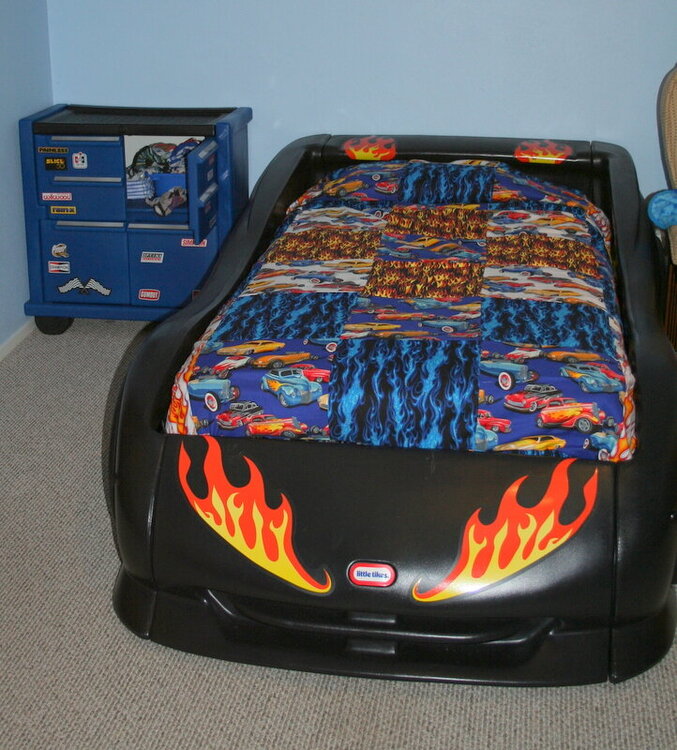 The finished quilt on his new bed! Hot Rod!