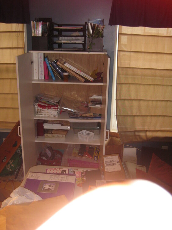 Open Cabinet in our craft room b/4 cleanup