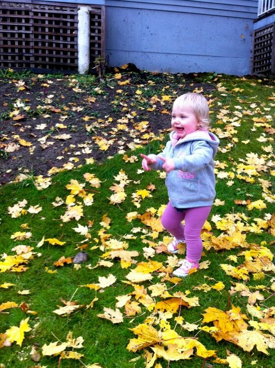 playing in autumn leaves