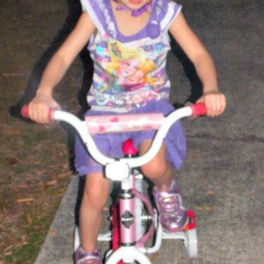 my grand daughter on her new bike