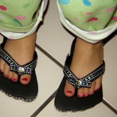 Black ribbon flip flops