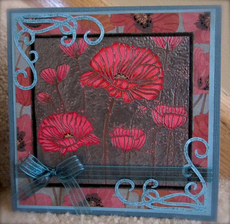 Red poppies on pewter with poppy paper