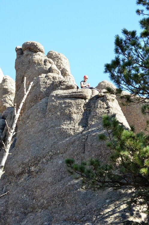 Climber on tob of pinnacle on Needles HWY, SD