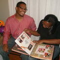 Brian and Raven looking through their album