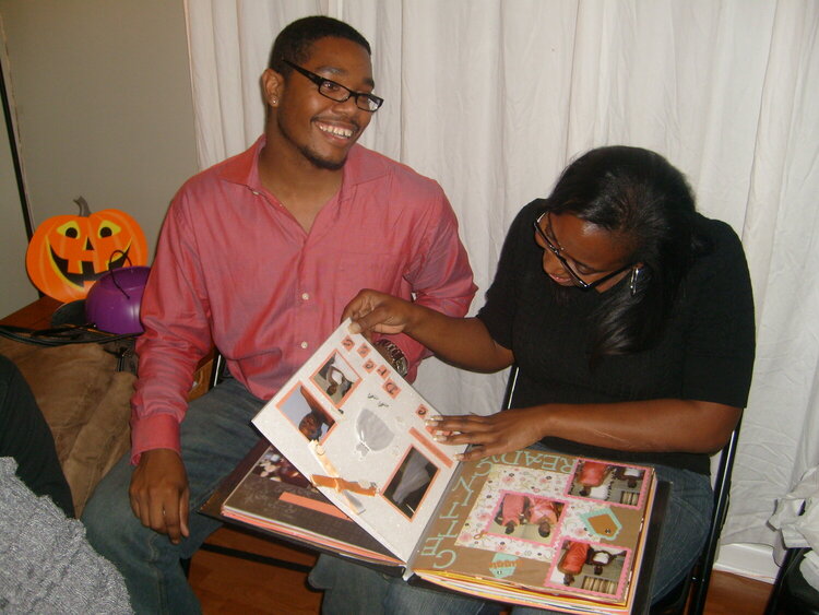 Brian and Raven looking through their album