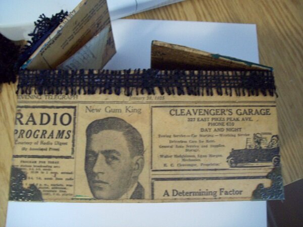 Front/outside of altered cigar box  vintage 1928 newsprint