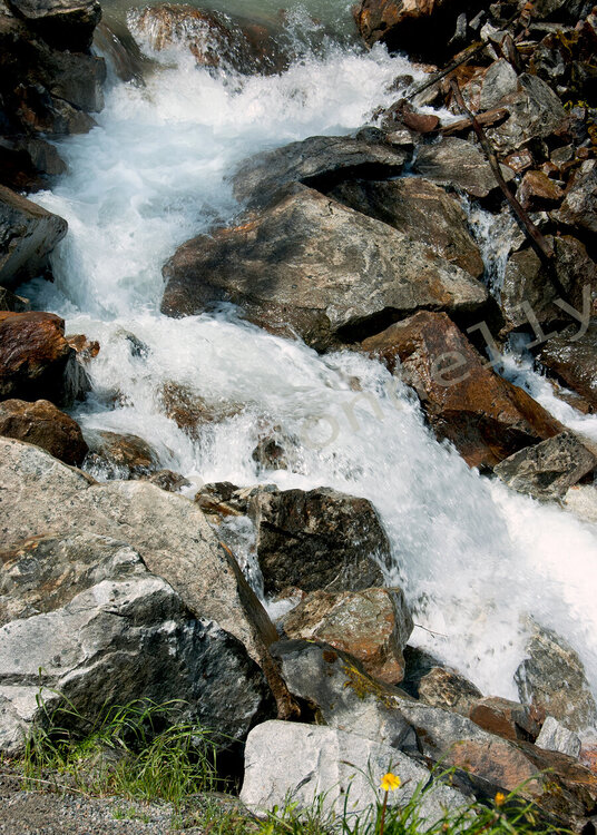 Alaska river with a rushing rock waterfall