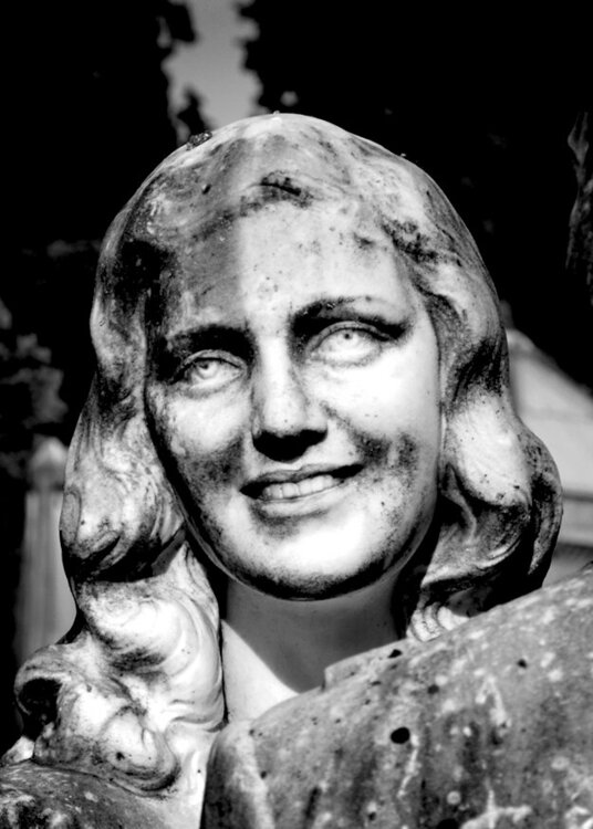 Face of a young woman  in San Miniato Cemetery in Florence Italy