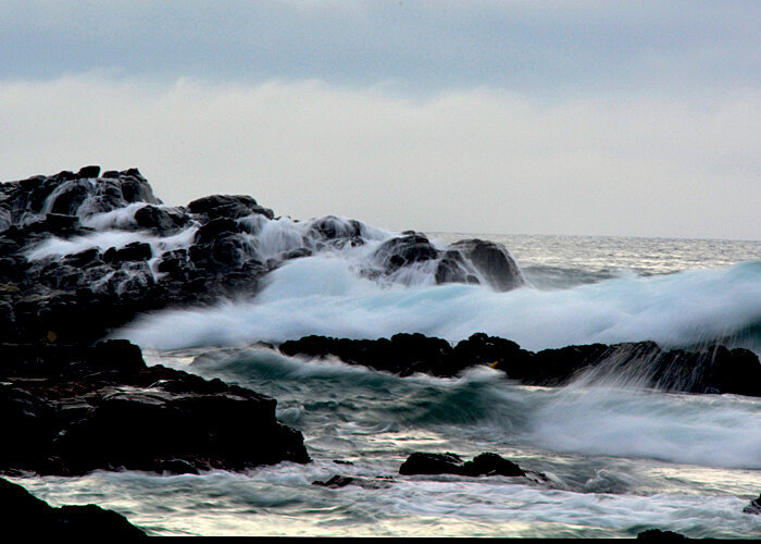 crashing waves over rocks photograph