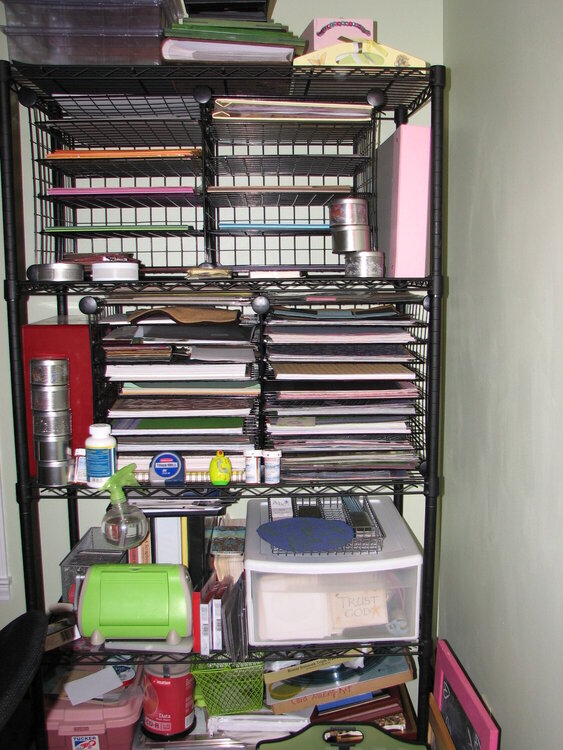 Black shelf for misc storage and paper storage.