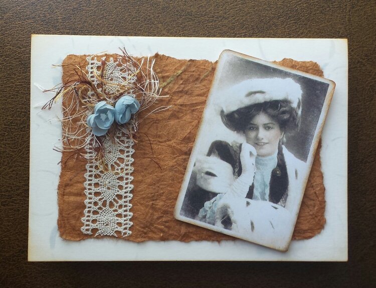 Vintage card oranged-colored brown with pale blue flowers