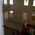 Looking from the top of the stairs back down into Living Room/Entry