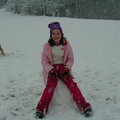 Emily sitting on her snowman