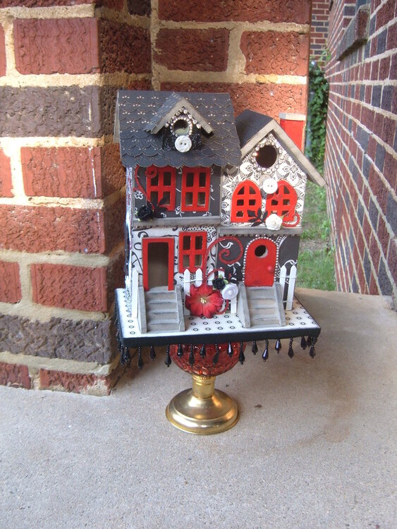 Black white and red altered birdhouse