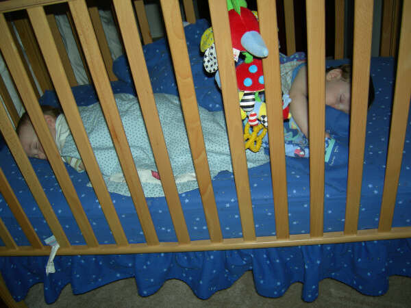 Twins sleeping in their crib