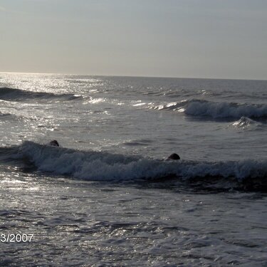 Katy and Hayley swimming in the ocean while the sunrises