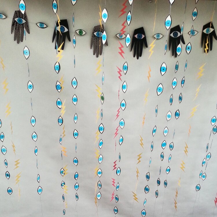 Evil Eyes and Lightening bolt sewn paper decorations