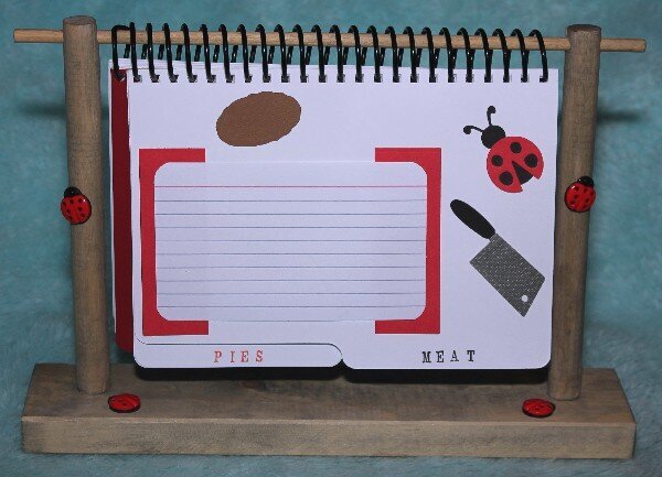 Lady Bug Cookbook on wood stand