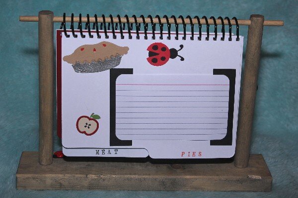 Lady Bug Cookbook on wood stand