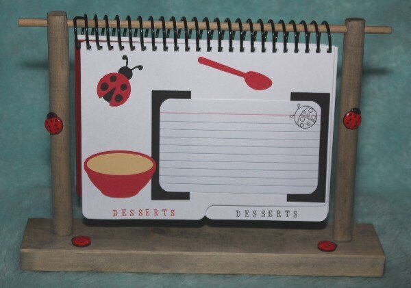 Lady Bug Cookbook on wood stand